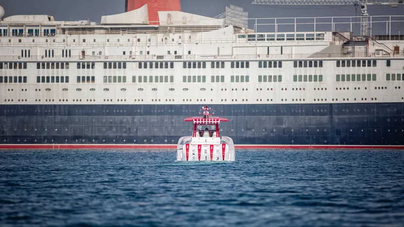 A powerboat on the water in front of an ocean liner