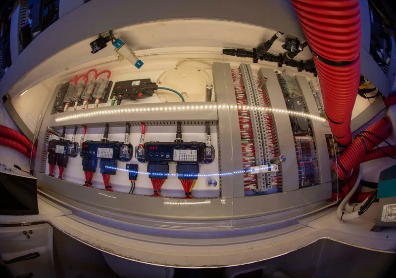 Electrical components and cable connections inside an onboard cabinet