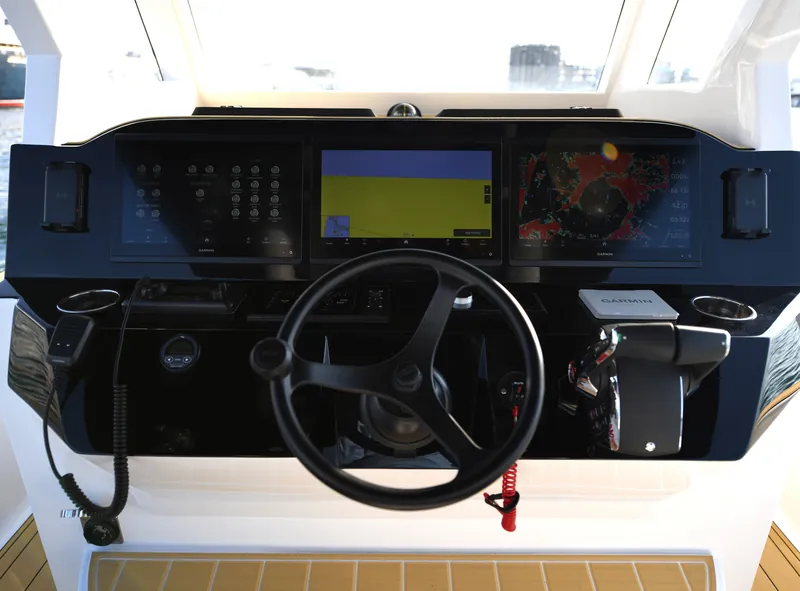 A finished helm console with navigation displays and steering wheel