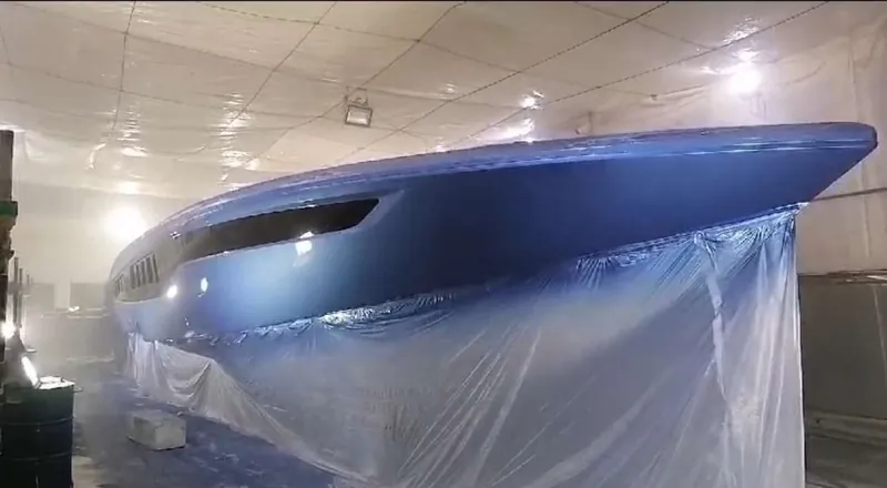 A hull in the workshop with masking around the lower surfaces