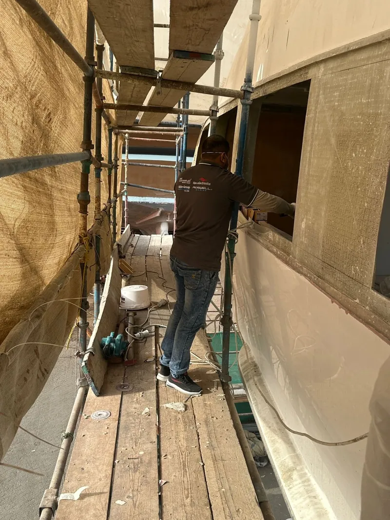 Work along a yacht's side deck during refit