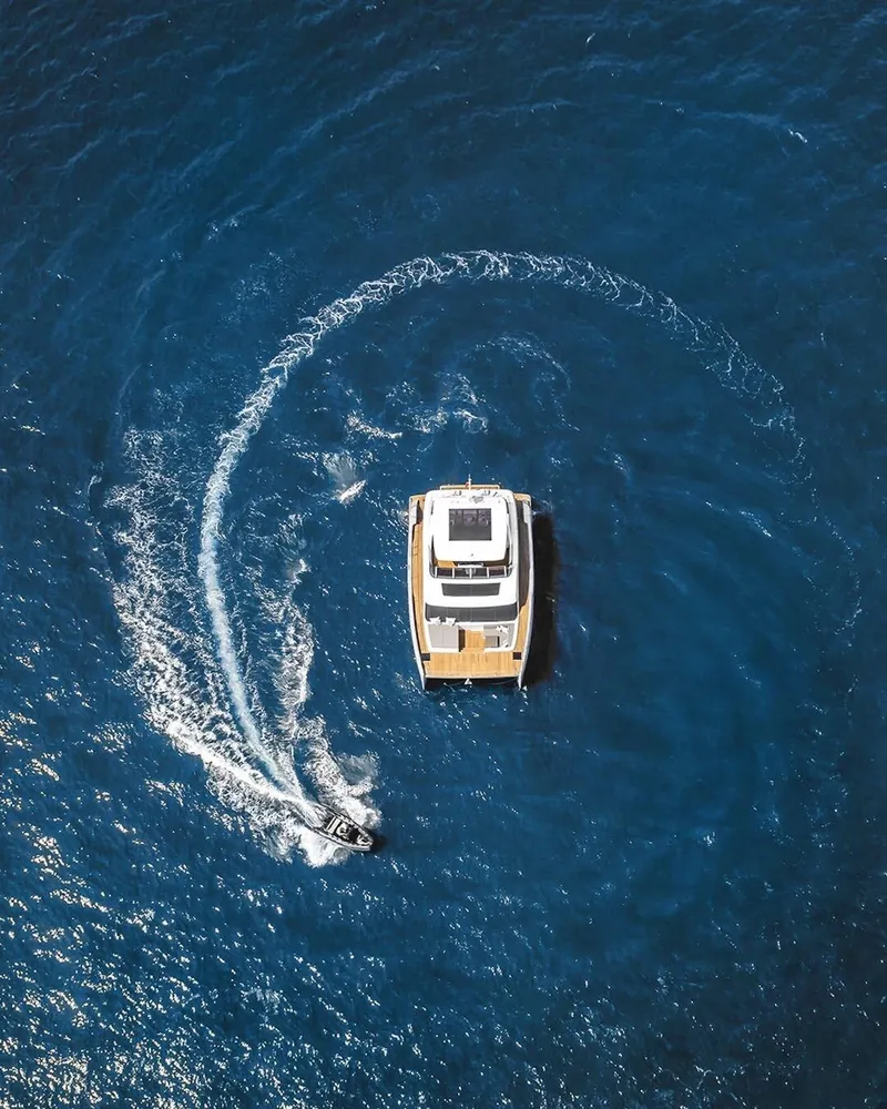 A powerboat and its curved wake, viewed from above